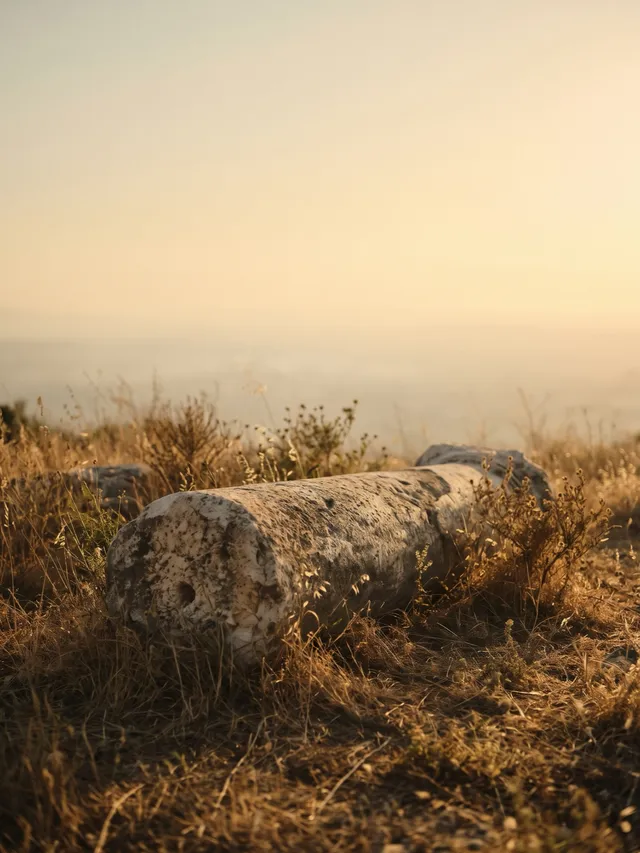 A marble column fragment in golden light